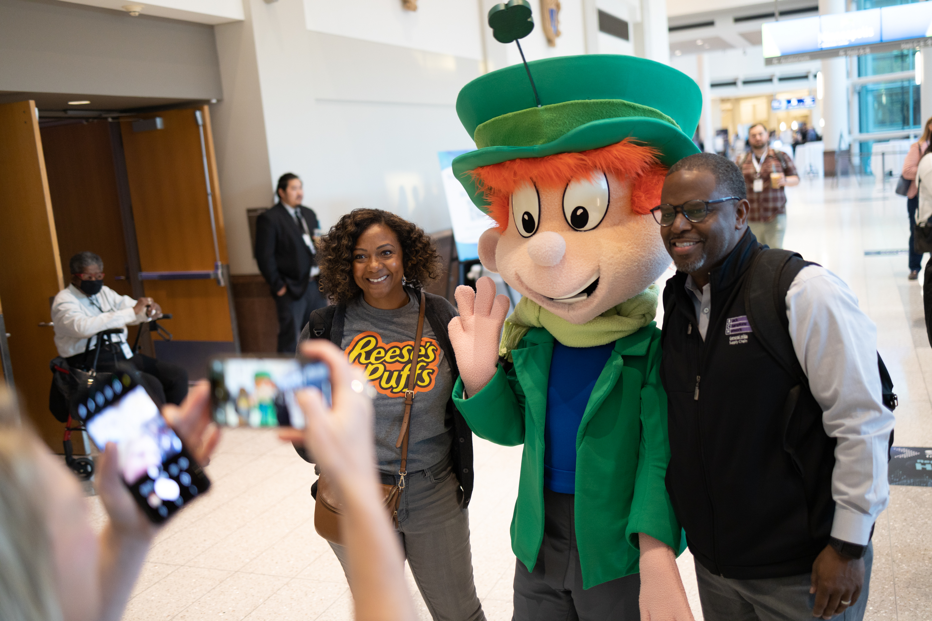 Employees taking a photo with Lucky the Leprechaun